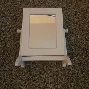 Mirror with jewelry storage